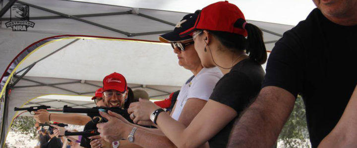 Female instructor showing female shooter proper grip